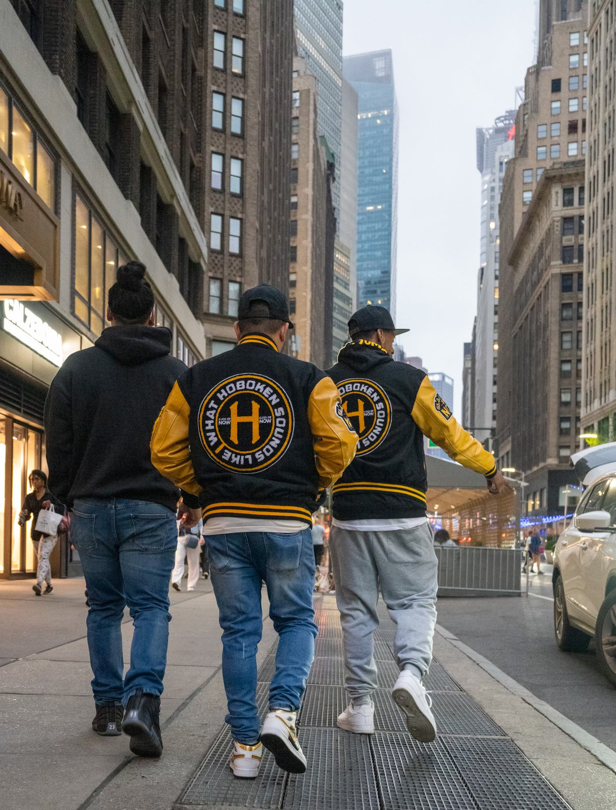 What Hoboken Sounds Like team walking through New York City in branded varsity jackets